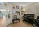 Well-lit office space with a piano and view of the upstairs at 17332 E Lake Ln, Aurora, CO 80016