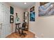 Creative studio space featuring hardwood floors, art display, and rolling chair at 17332 E Lake Ln, Aurora, CO 80016