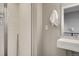 Modern bathroom with frameless glass shower and white, rectangular sink with towel hook at 2473 S Cherokee St, Denver, CO 80223