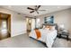Spacious bedroom with a ceiling fan, soft gray walls, a sliding barn door, and neutral decor at 2473 S Cherokee St, Denver, CO 80223