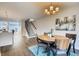 Bright dining area adjacent to the kitchen with a modern chandelier and staircase at 2473 S Cherokee St, Denver, CO 80223