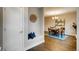 Inviting dining area with wood floors, a modern chandelier, and a built-in bench with accent pillows at 2473 S Cherokee St, Denver, CO 80223