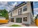 Modern home featuring a balcony and patio, complemented by stylish gray and white exterior paint and a well-maintained yard at 2473 S Cherokee St, Denver, CO 80223