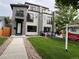 Contemporary home with gray siding, black accents, small balconies, and a well-maintained front lawn at 2473 S Cherokee St, Denver, CO 80223