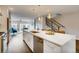 Contemporary kitchen with stainless steel appliances and an island featuring a sink and dishwasher at 2473 S Cherokee St, Denver, CO 80223
