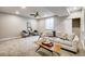 Relaxing living room with plush carpet, a neutral sofa with decorative pillows, and plenty of natural light at 2473 S Cherokee St, Denver, CO 80223