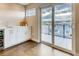 Stylish room with a sleek kitchenette and glass sliding doors leading to a balcony with city views at 2473 S Cherokee St, Denver, CO 80223