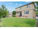Spacious backyard with lawn, patio, and landscaping at 10197 Quintero St, Commerce City, CO 80022