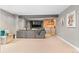 Finished basement with a wet bar, brick accent wall, and comfortable sectional sofa at 10197 Quintero St, Commerce City, CO 80022
