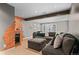 Finished basement boasting a large sectional sofa and convenient wet bar with beverage storage at 10197 Quintero St, Commerce City, CO 80022