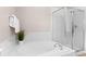Modern bathroom featuring a soaking tub with tile surround and glass shower enclosure at 10197 Quintero St, Commerce City, CO 80022