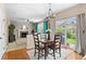 Cozy dining area adjacent to living room, with backyard view and stylish lighting at 10197 Quintero St, Commerce City, CO 80022