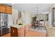 Open concept kitchen flowing into the dining area, with staircase nearby at 10197 Quintero St, Commerce City, CO 80022