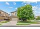 Charming two-story home with a two-car garage, mature tree, and well-manicured lawn at 10197 Quintero St, Commerce City, CO 80022