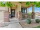 Inviting covered front porch with brick pillars, decorative accents, and landscaped surroundings at 10197 Quintero St, Commerce City, CO 80022
