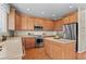 Modern kitchen with stainless appliances, central island, and plenty of cabinet space at 10197 Quintero St, Commerce City, CO 80022