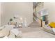 Bright and airy living room with tall ceilings, neutral decor, and comfortable seating arrangements at 10197 Quintero St, Commerce City, CO 80022