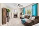 Inviting living room featuring a cozy fireplace and a comfortable, oversized sectional sofa at 10197 Quintero St, Commerce City, CO 80022