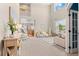 Bright and spacious living room with soaring ceilings, neutral tones, and large windows at 10197 Quintero St, Commerce City, CO 80022