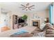 Comfortable living room showcasing a stylish entertainment center and a warm fireplace at 10197 Quintero St, Commerce City, CO 80022