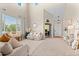 Bright and airy living room with tall ceilings, neutral decor, and comfortable seating arrangements at 10197 Quintero St, Commerce City, CO 80022