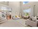 Bright and spacious living room with soaring ceilings, neutral tones, and large windows at 10197 Quintero St, Commerce City, CO 80022