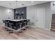 Stylish basement bar area with modern lighting, sleek countertops, and comfortable seating at 7125 Skygazer St, Castle Pines, CO 80108