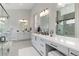 Bright bathroom with double vanities, a large mirror, and a walk-in shower at 7125 Skygazer St, Castle Pines, CO 80108