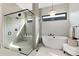 Modern bathroom featuring a soaking tub, glass shower, and contemporary fixtures at 7125 Skygazer St, Castle Pines, CO 80108