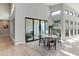 Elegant dining area with modern chandelier, glass patio doors, and contemporary decor at 7125 Skygazer St, Castle Pines, CO 80108