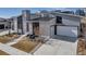 Contemporary exterior boasts unique architecture, stone accents, and a well-manicured landscape at 7125 Skygazer St, Castle Pines, CO 80108