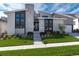 Striking home with a stone facade, modern design, and lush green lawn offers curb appeal at 7125 Skygazer St, Castle Pines, CO 80108
