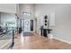 Bright foyer featuring hardwood floors, high ceilings, decorative walls, and a glass encased staircase at 7125 Skygazer St, Castle Pines, CO 80108