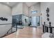 Bright foyer features modern lighting, wood floors, and glass-enclosed office with contemporary decor at 7125 Skygazer St, Castle Pines, CO 80108