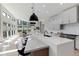 Bright, open kitchen flowing into the living area, featuring a large island, modern appliances, and ample natural light at 7125 Skygazer St, Castle Pines, CO 80108