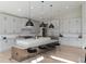Spacious kitchen with large island, stainless steel appliances, modern cabinetry, and hardwood floors at 7125 Skygazer St, Castle Pines, CO 80108