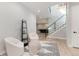 Bright sitting area with minimalist decor, modern staircase and open access to the bar at 7125 Skygazer St, Castle Pines, CO 80108
