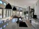 Open floor plan living area with large windows, a fireplace, and modern finishes at 7125 Skygazer St, Castle Pines, CO 80108