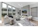 Modern living room with large windows, fireplace, and stylish decor offers a cozy atmosphere at 7125 Skygazer St, Castle Pines, CO 80108