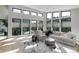 Bright living room features large windows, light wood floors, and a comfortable seating area at 7125 Skygazer St, Castle Pines, CO 80108