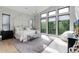 Airy main bedroom with large windows offering scenic views and a comfortable sitting area at 7125 Skygazer St, Castle Pines, CO 80108