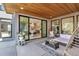Outdoor patio with a covered ceiling, stylish furniture, and views to the home's interior at 7125 Skygazer St, Castle Pines, CO 80108