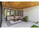 Covered patio with comfortable seating and a wood-paneled ceiling at 7125 Skygazer St, Castle Pines, CO 80108