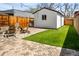 Inviting backyard with artificial turf, patio, and stylish outdoor seating area for entertaining at 1452 S Logan St, Denver, CO 80210
