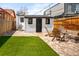 Cozy backyard featuring a paved patio, a small shed, and a well-maintained lawn at 1452 S Logan St, Denver, CO 80210