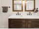 Elegant bathroom features a double vanity, framed mirrors, and modern lighting fixtures at 1452 S Logan St, Denver, CO 80210