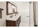 Bright bathroom featuring a double vanity, shiplap accent wall, and hexagon tile flooring at 1452 S Logan St, Denver, CO 80210