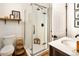 Bathroom featuring a glass-enclosed shower with subway tile, a sink with wood accents, and a toilet at 1452 S Logan St, Denver, CO 80210