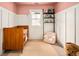 Charming Bedroom with a pink ceiling, board and batten walls, and a classic wooden crib at 1452 S Logan St, Denver, CO 80210