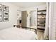 Bedroom featuring a black metal bed frame and shelves, with views of a modern kitchen at 1452 S Logan St, Denver, CO 80210